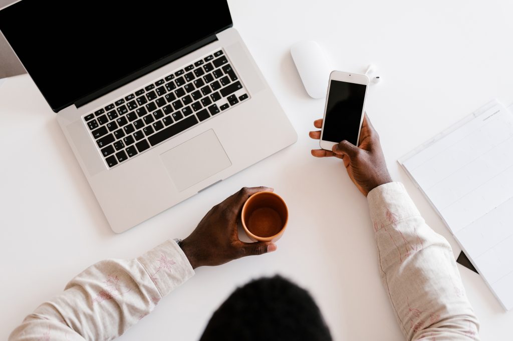 image of a man drinking coffee and laptop computer